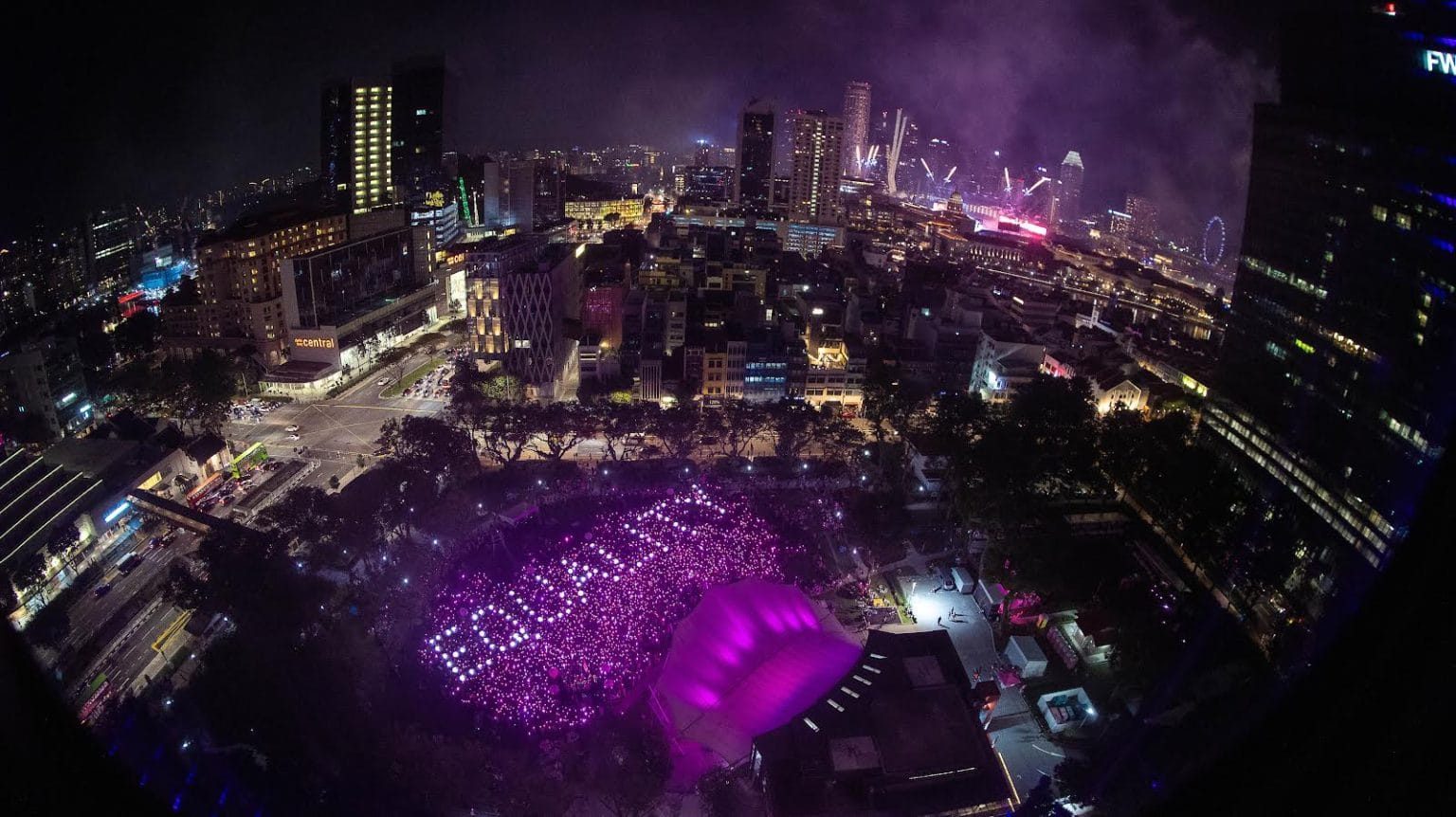 An aerial shot of a large gathering in Hong Lim Park for Pink Dot 16, with pink lights and white lights that spell out EQUALITY