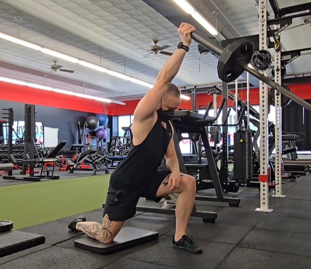 Sirus doing a half-kneeling single arm landmine press