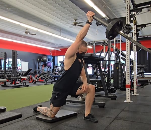 Sirus doing a half-kneeling single arm landmine press